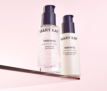 TimeWise Nighttime Recovery and TimeWise Daytime Defender SPF 30 pictured on a glass shelf surrounded by a light pink background