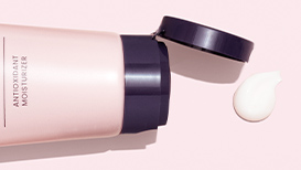 An open TimeWise Antioxidant Moisturizer next to a dime-sized dollop of product on a light pink background
